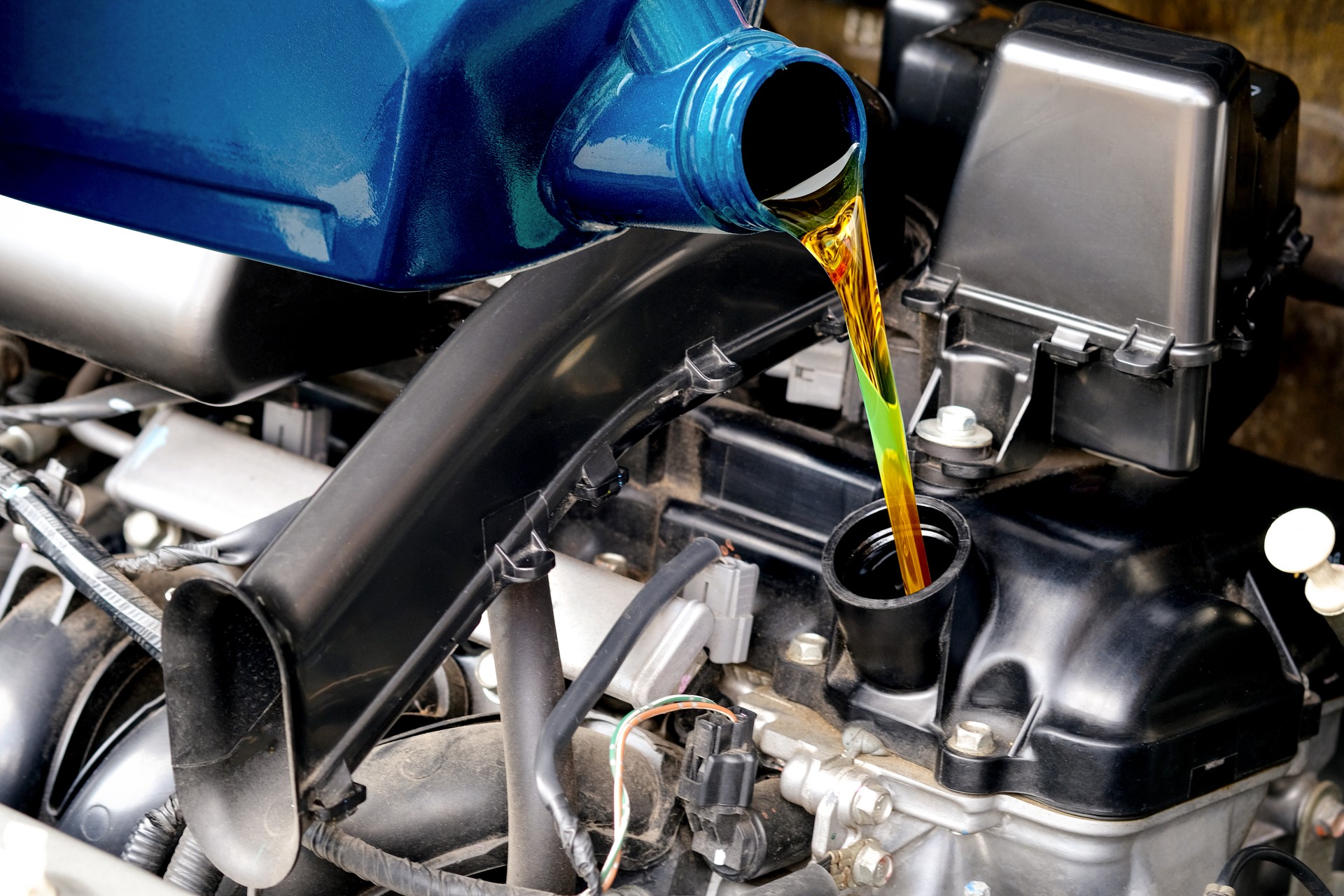 Refueling and pouring oil quality into the engine motor car Transmission and Maintenance Gear .Energy fuel concept.